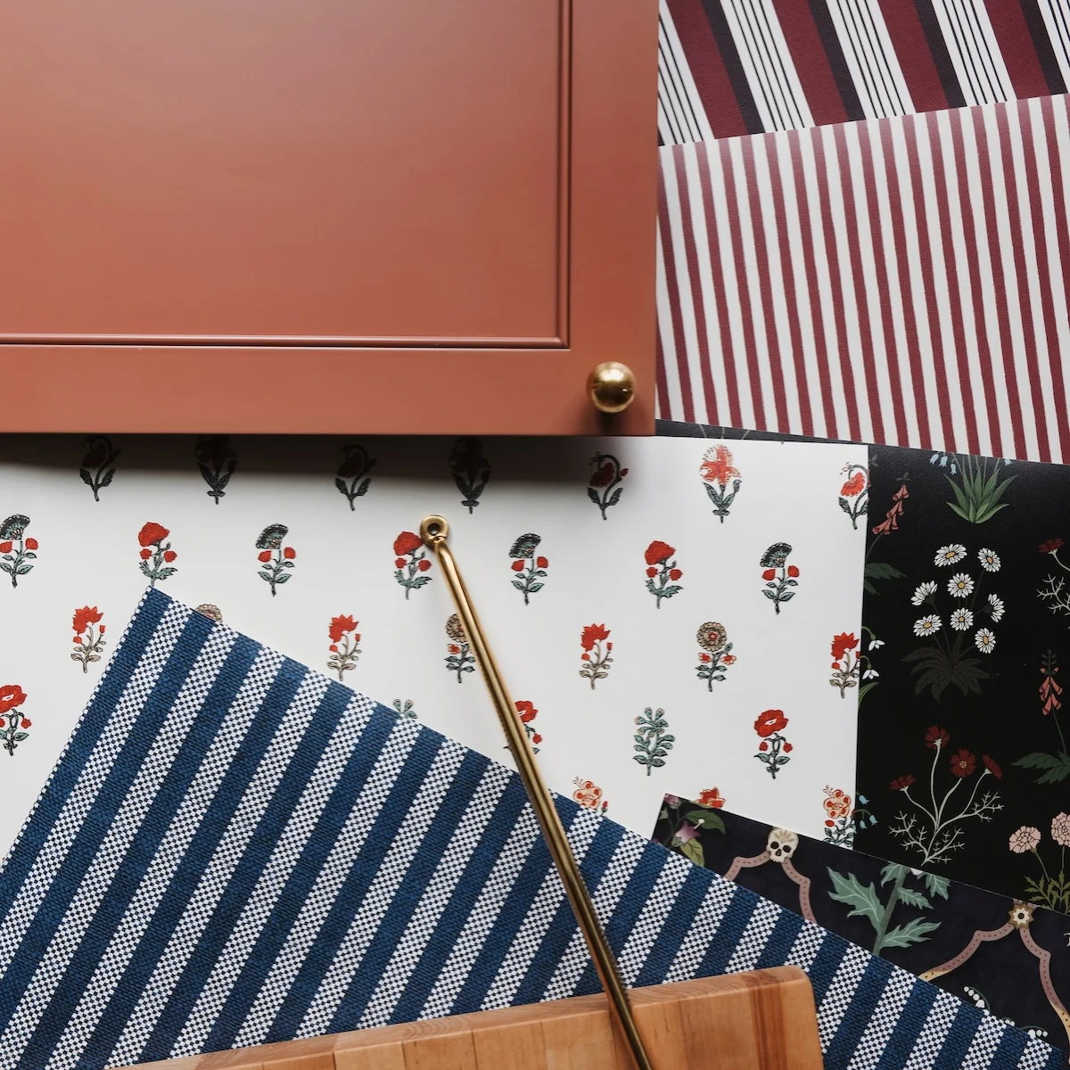 Wallpaper samples next to a piece of cabinetry