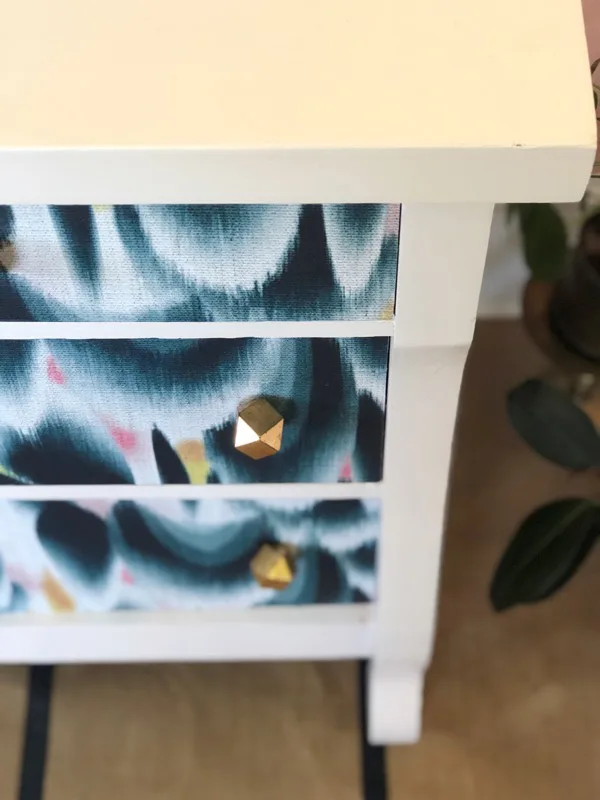 Close up of the side of the finished dresser and drawers. Gold drawer knobs are added.