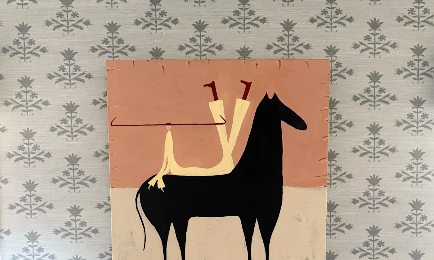 Close up sage blue floral block print wallpaper behind a horse painting.