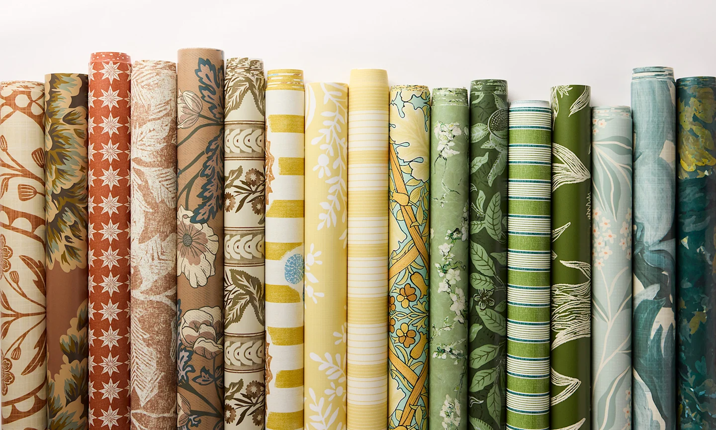 Rolls of wallpaper in colors trending in homes in 2026.