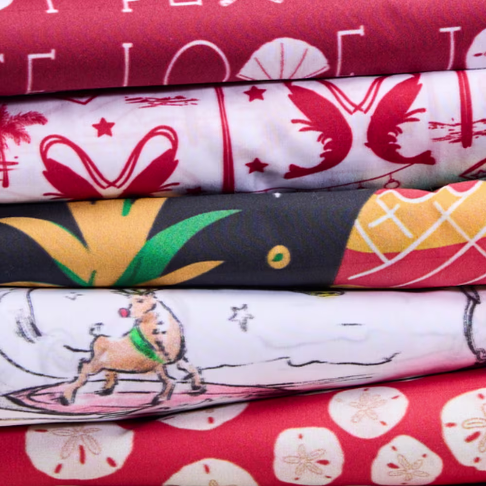Stack of island themed christmas fabrics