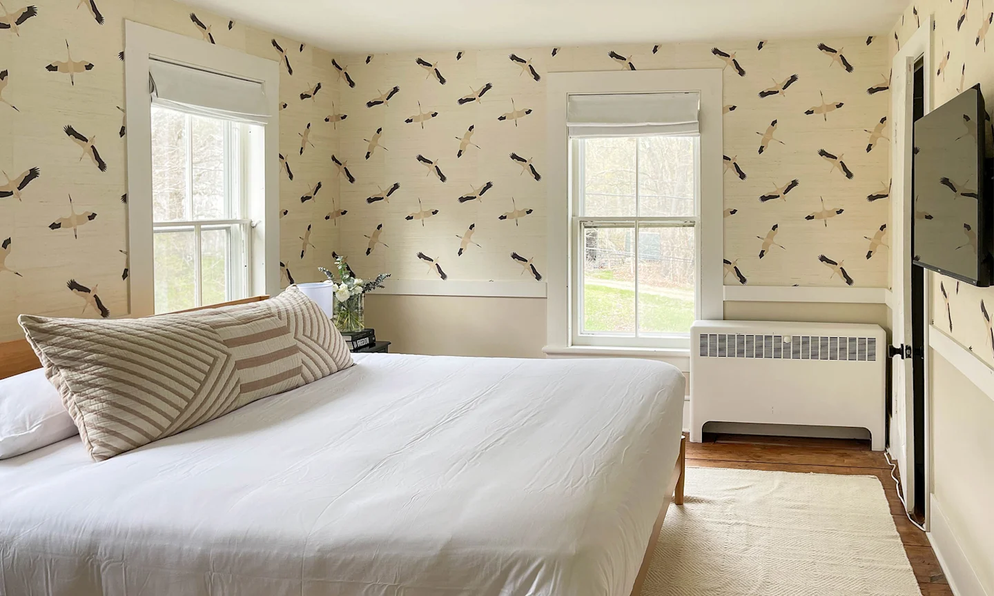 Bedroom with crane grasscloth wallpaper.