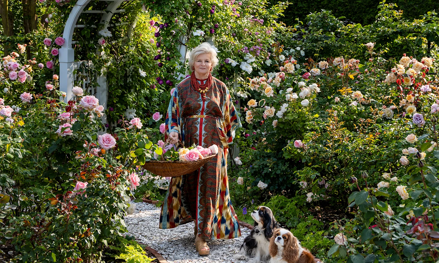 Charlotte Moss in a garden with two dogs.