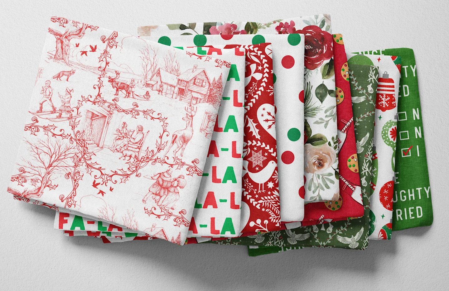Colorful folded Spoonflower fabric with a red and green Christmas theme