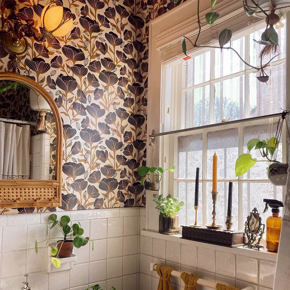 Black poppies wallpaper in a boho bathroom.