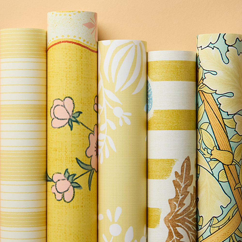 Rolls of warm yellow wallpapers.