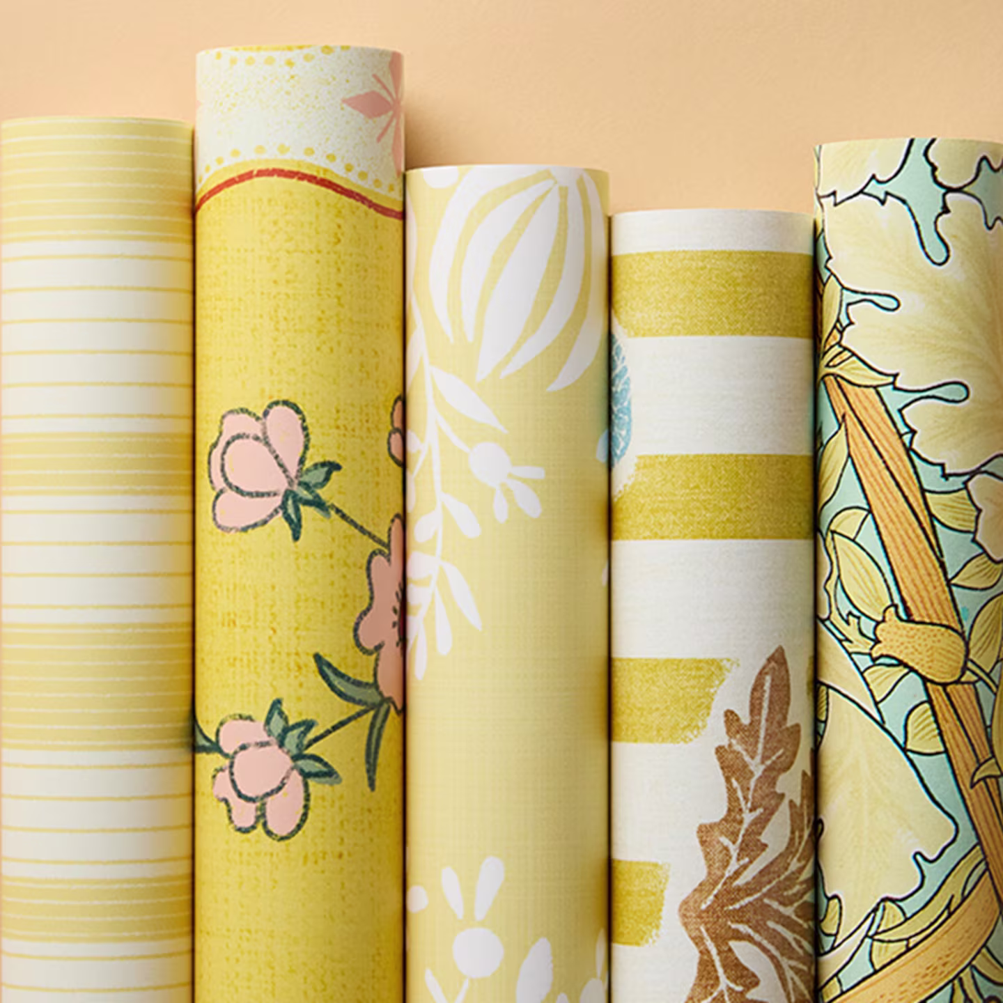 Rolls of warm yellow wallpapers.