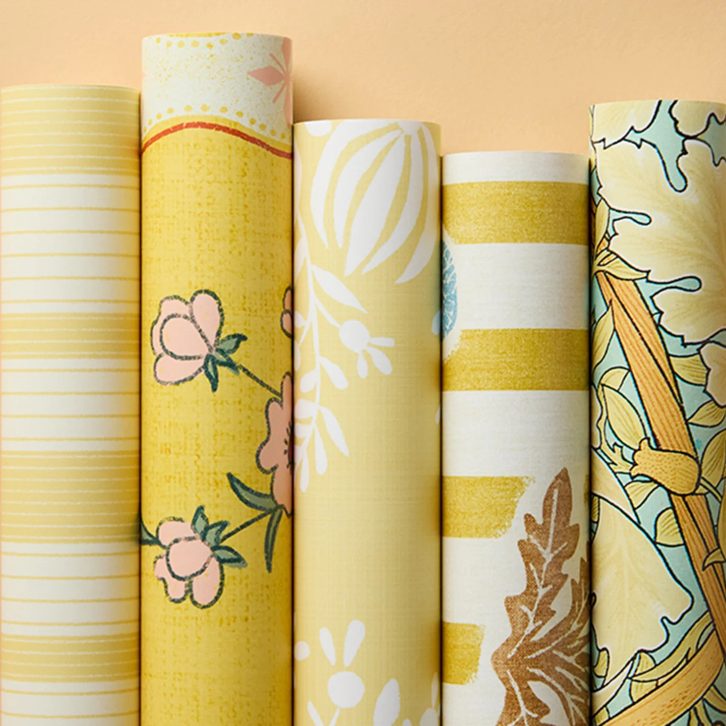 Rolls of warm yellow wallpapers.