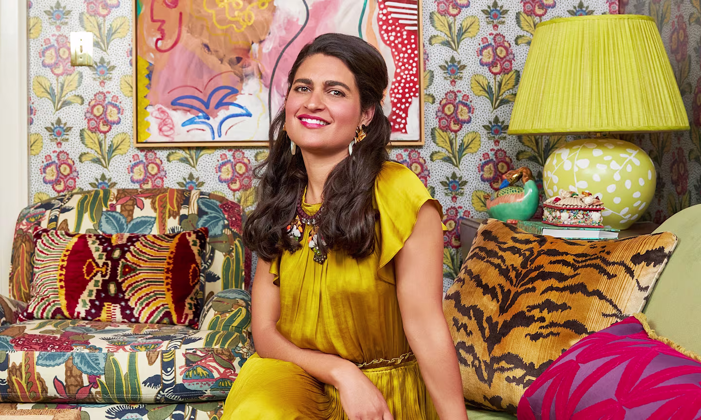 Isabel Ladd sitting in her designed maximalist living room.