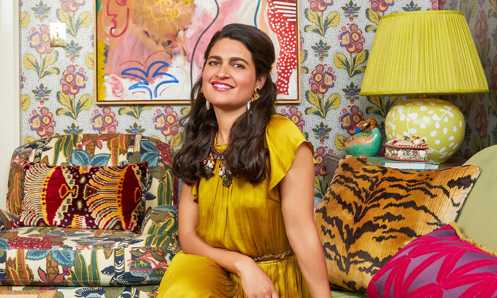 Isabel Ladd sitting in her designed maximalist living room.