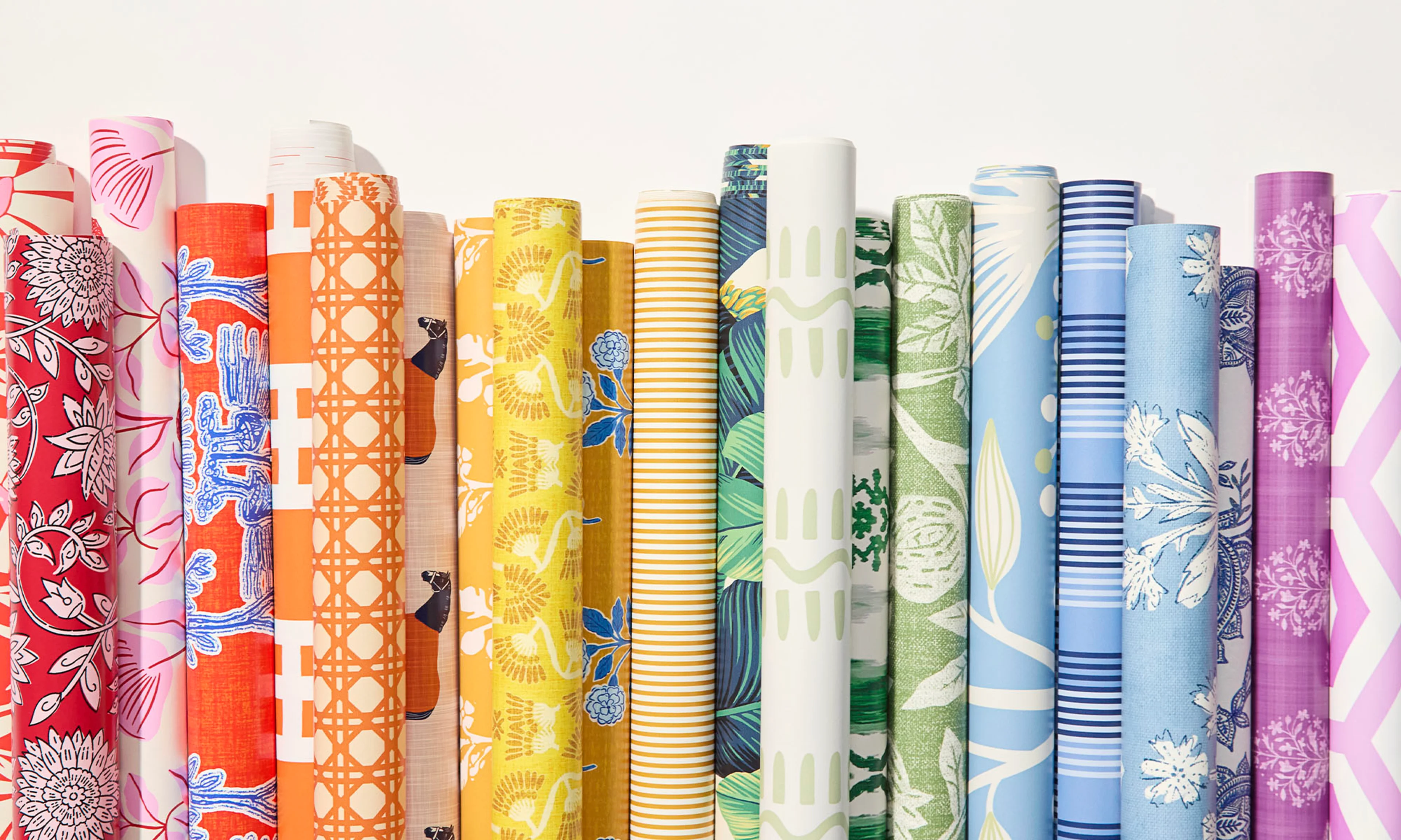 Rolls of rainbow colored wallpaper.