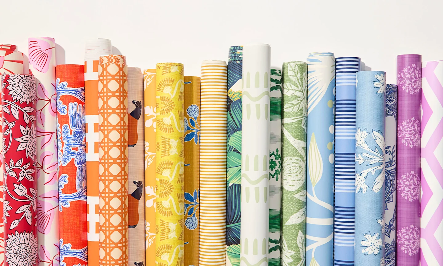 Rolls of rainbow colored wallpaper.