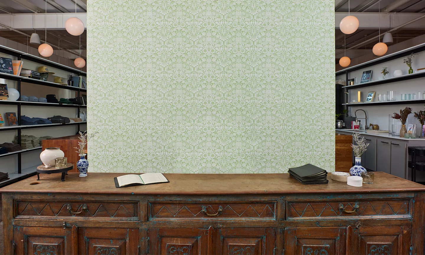 Vinyl wallpaper with a green ornate floral design in a commercial space.
