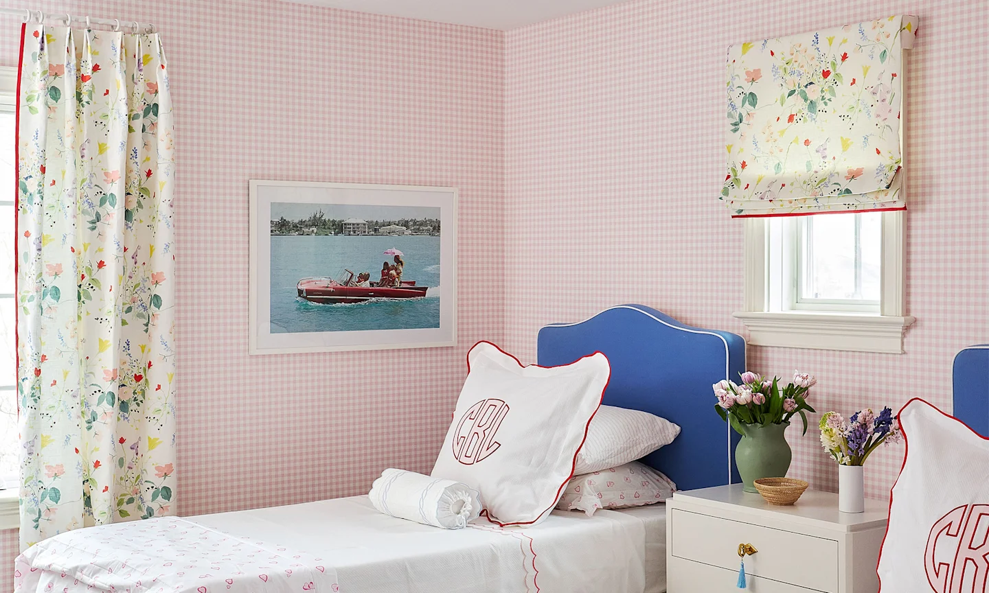 Bedroom with Pink gingham wallpaper and floral curtains.