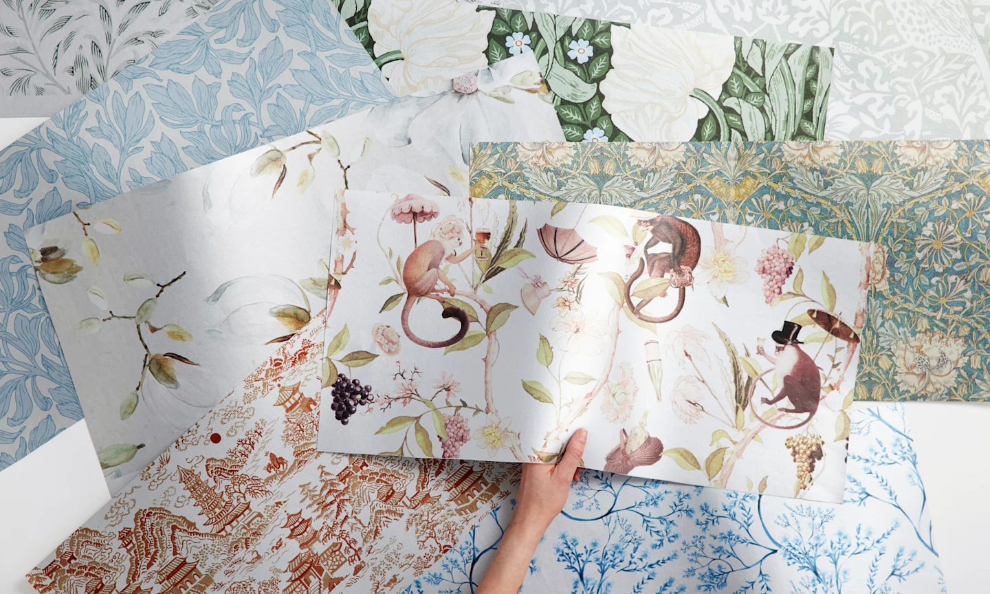 Hand holding metallic wallpaper samples