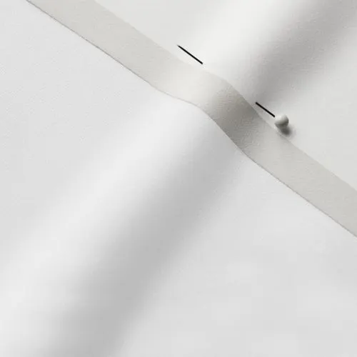 A close-up photo of white fabric with a pin running through it