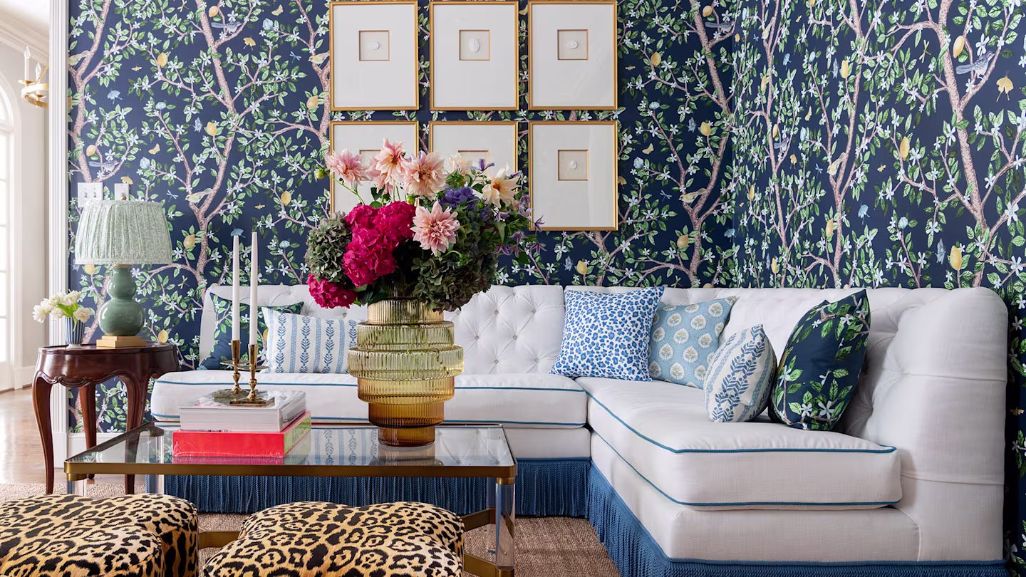 White and blue sectional couch in a blue living room with leopard seats.