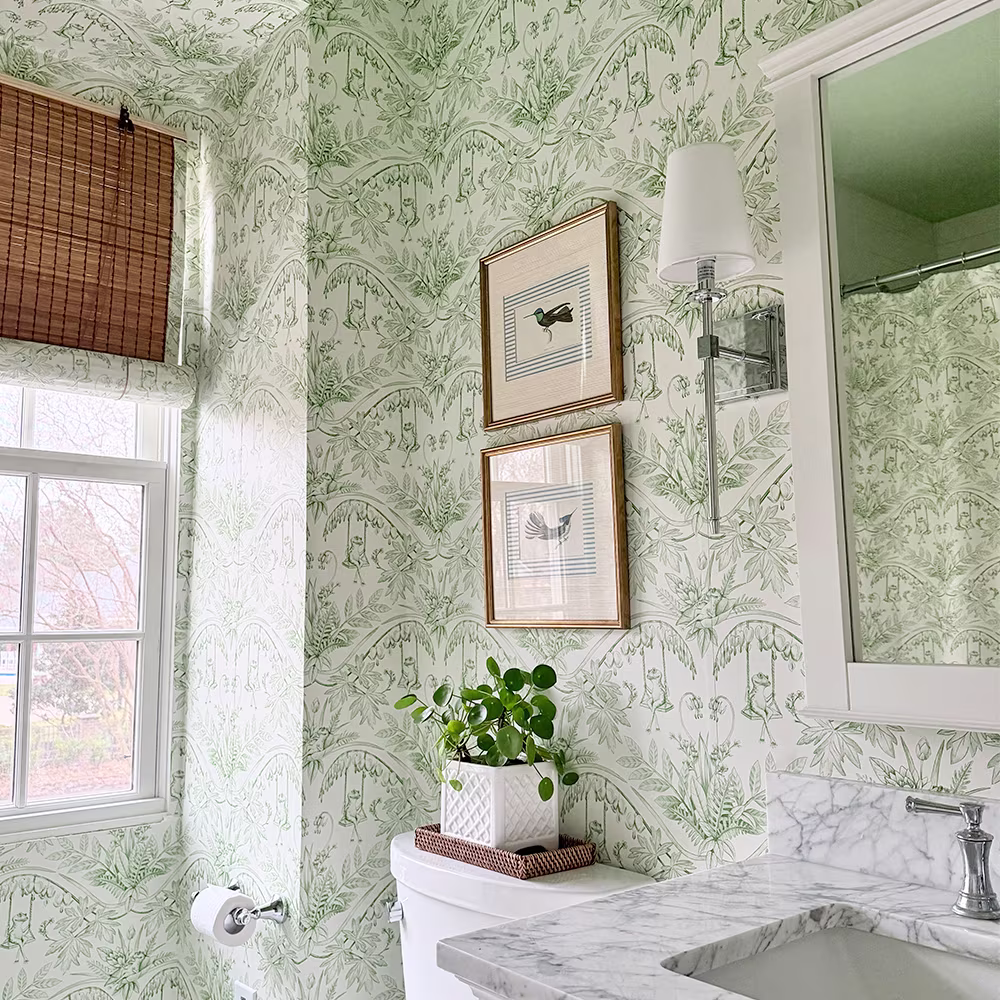 Green and cream frog toile wallpaper in a bathroom.