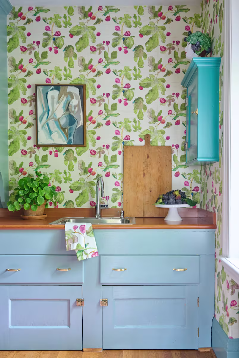 Blue kitchen with fig and fruit wallpaper and matching tea towel