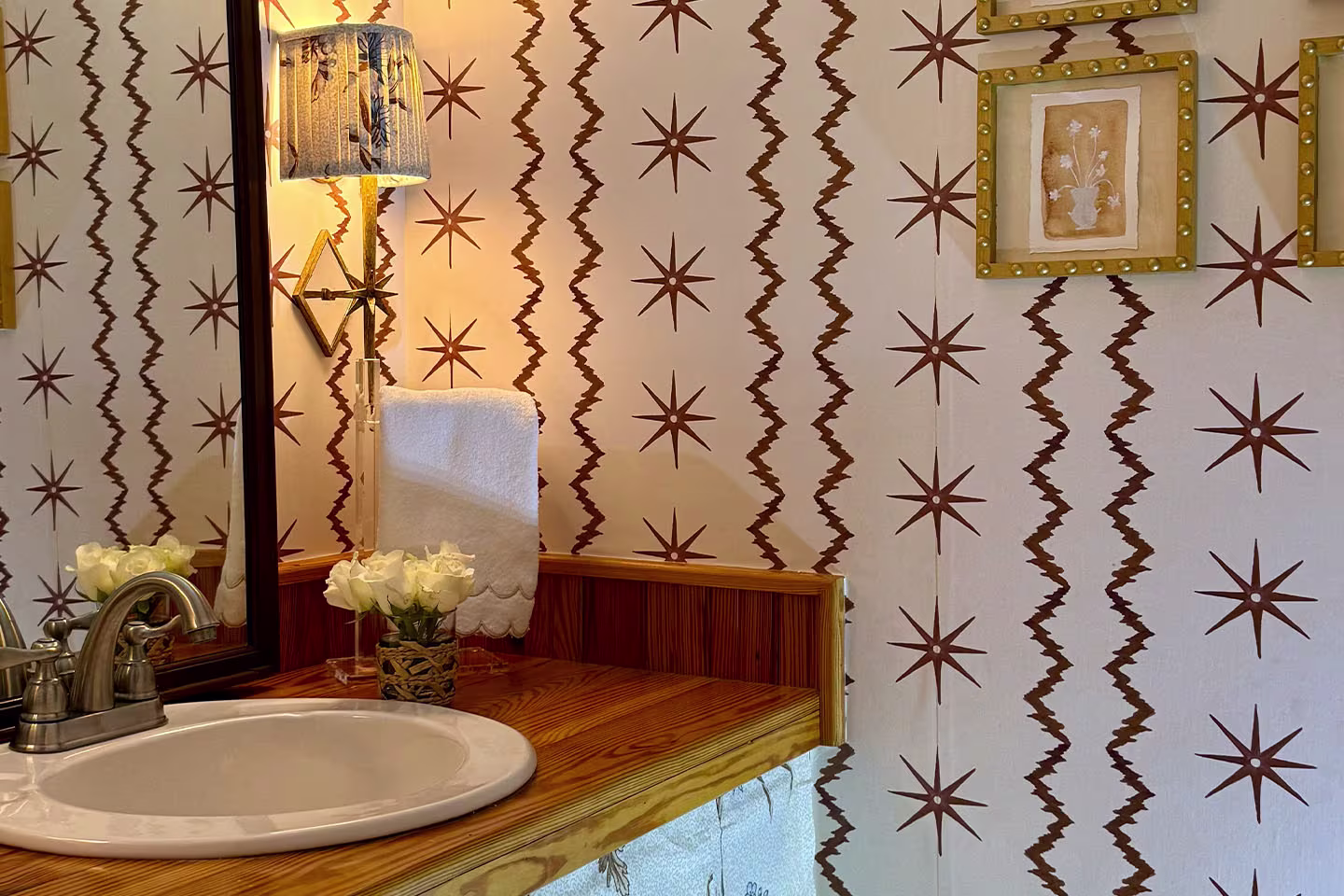 Powder room with Spoonflower wallpaper and DIY Spoonflower fabric sink skirt.