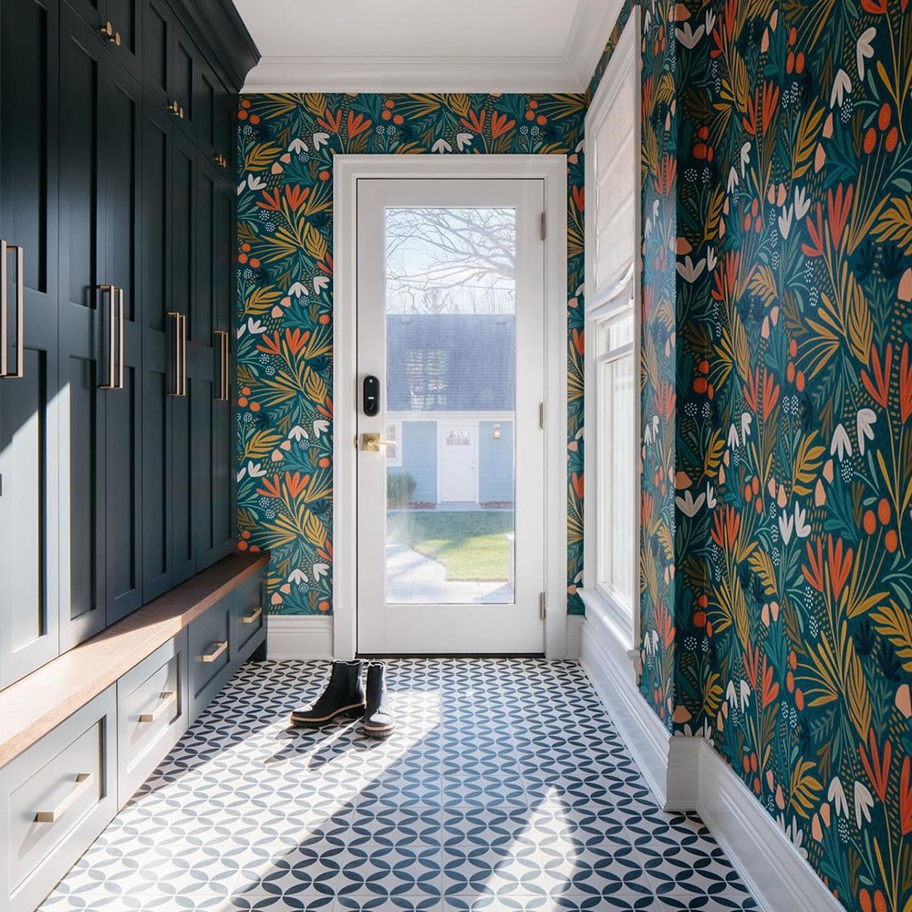 Entryway with dark botanical wallpaper and cabinetry.