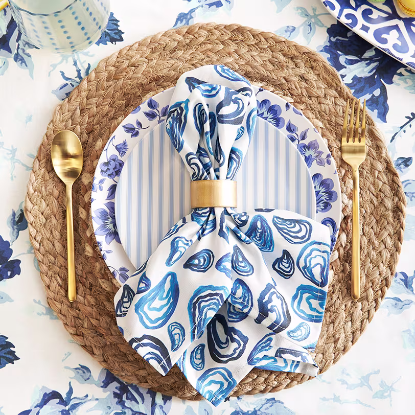 Blue oyster pattern napkin on a blue floral table cloth.