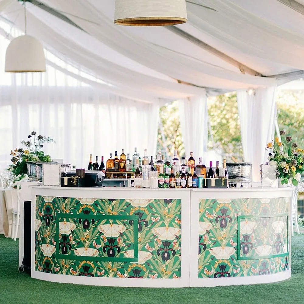 Wedding bar with moth and iris wallpaper around the bottom and fabric draped across the ceiling.