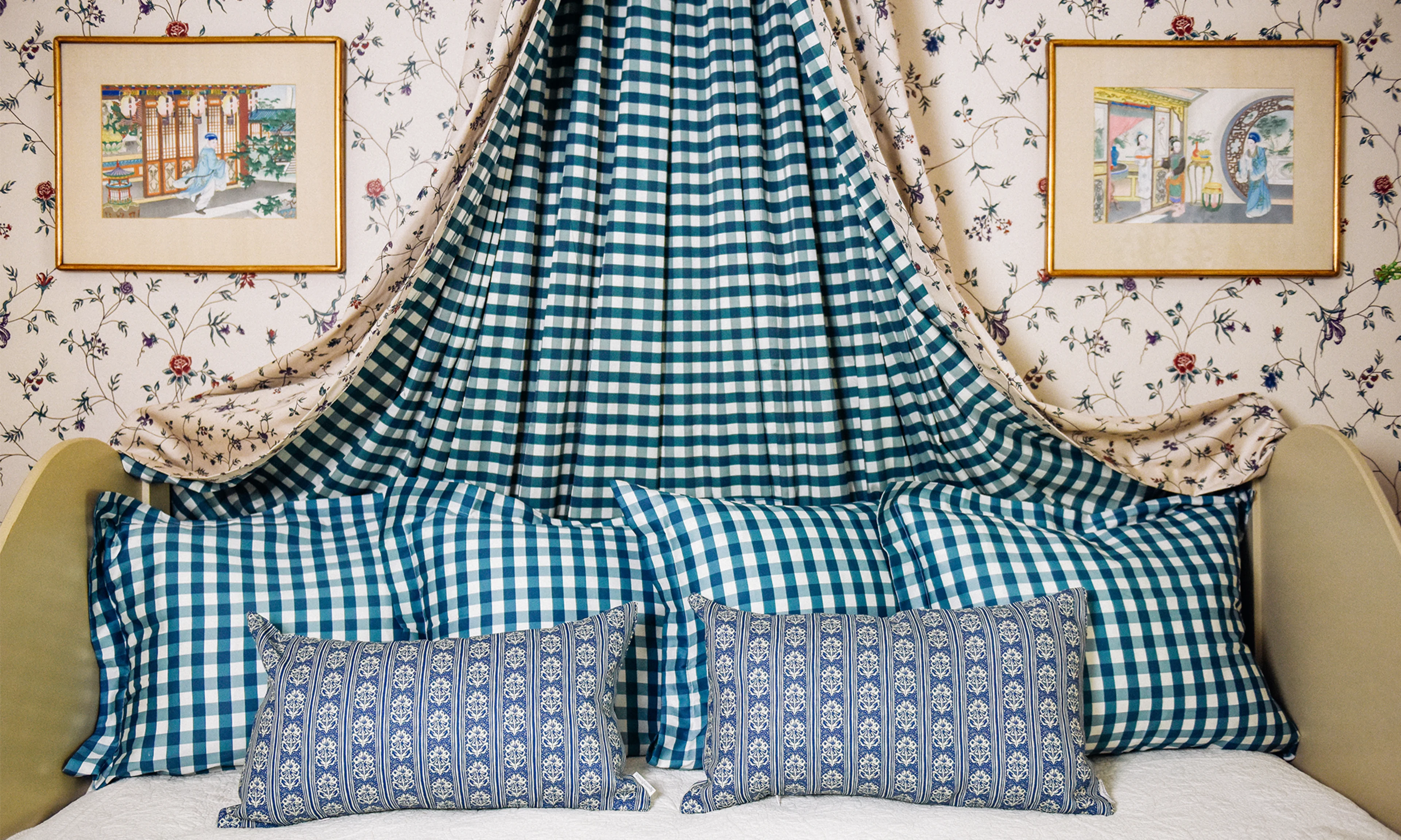 Guest bed with teal gingham shams and euro shams plus blue block print pattern lumbar throw pillows.