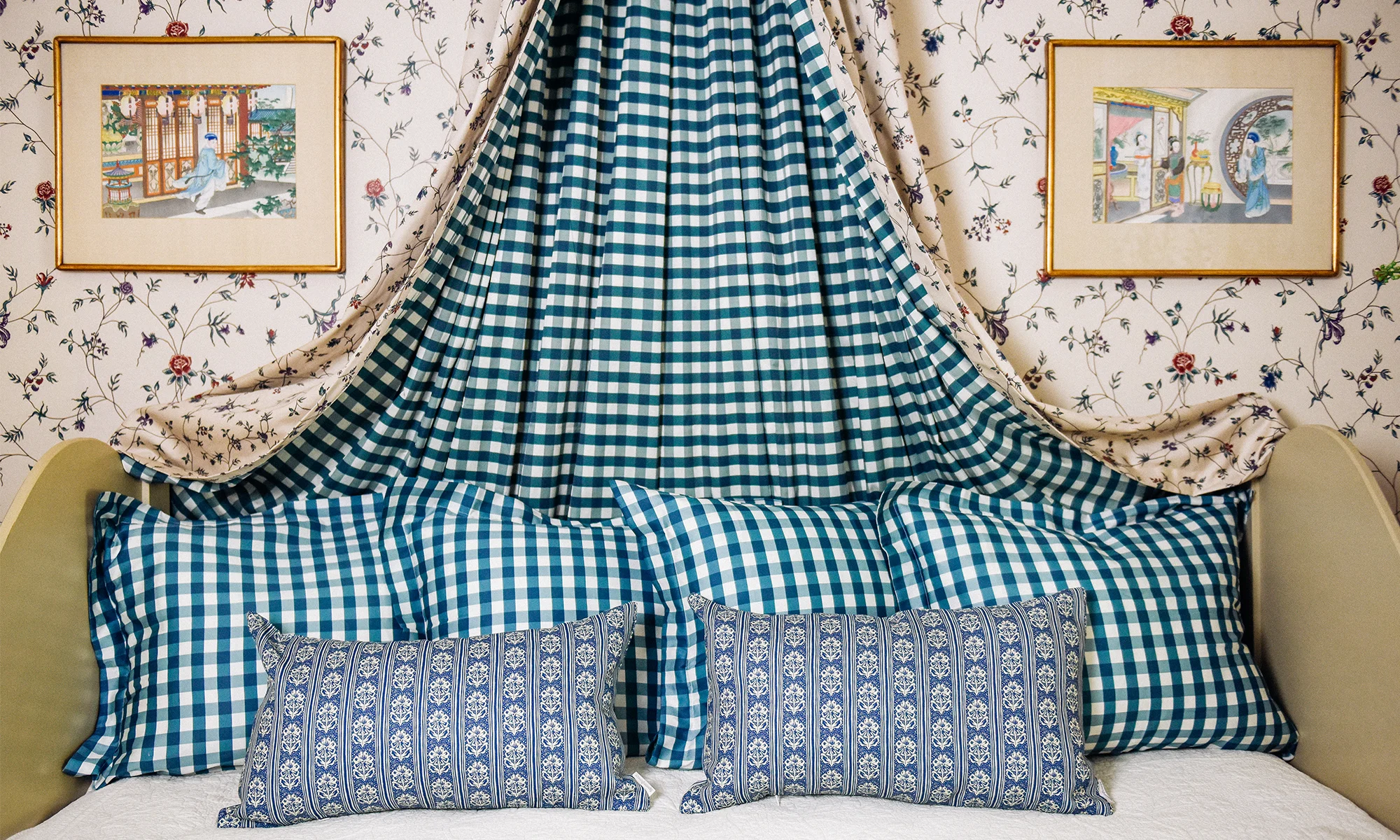 Guest bed with teal gingham shams and euro shams plus blue block print pattern lumbar throw pillows.