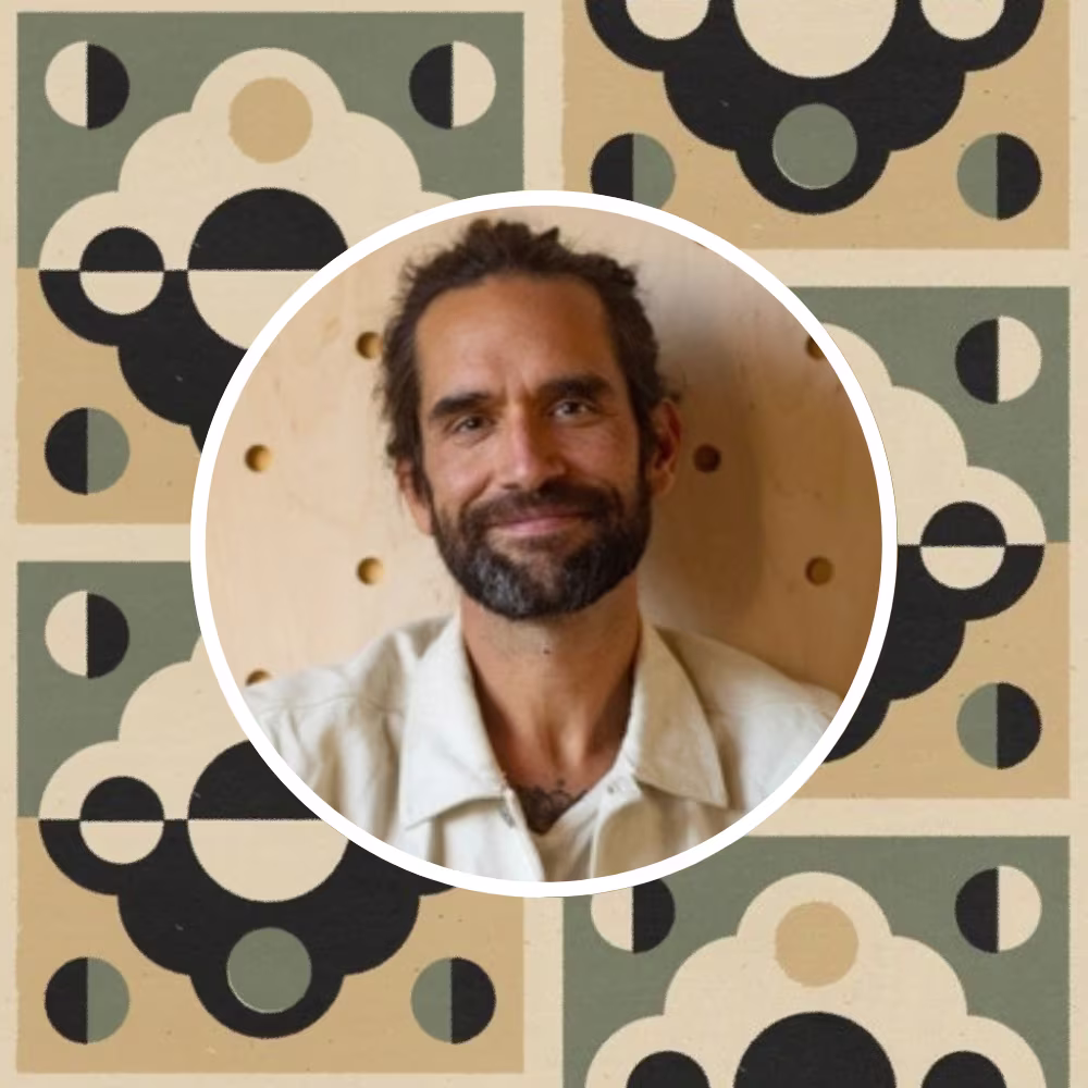 Headshot of Daren Magee with one of his prints in the background.