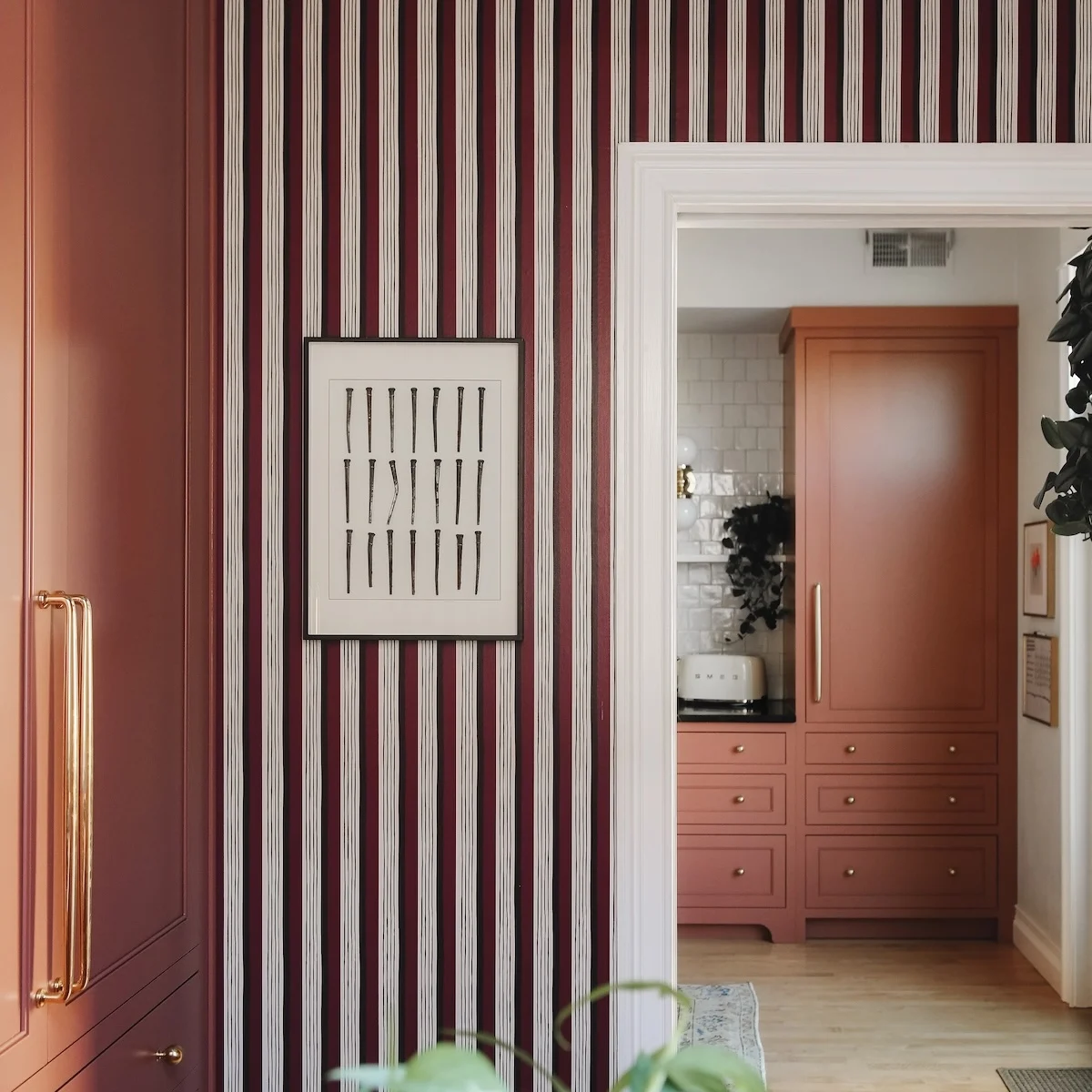 striped wallpaper and an open doorway