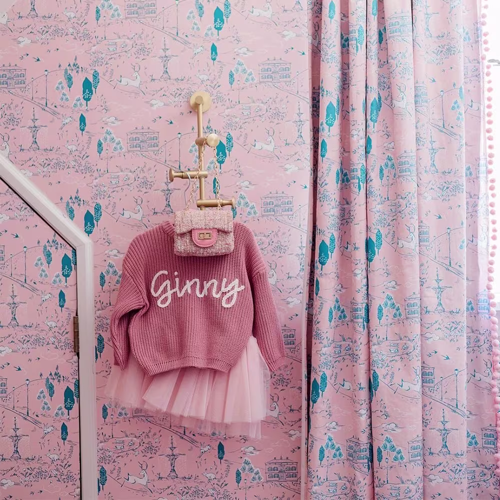 Pick toile wallpaper and curtains in a nursery.