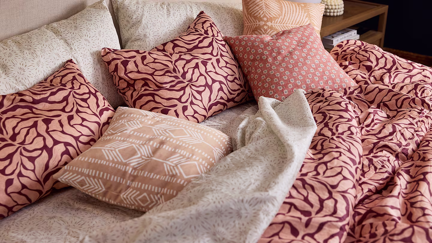 Burgundy with peach patterned bedding.