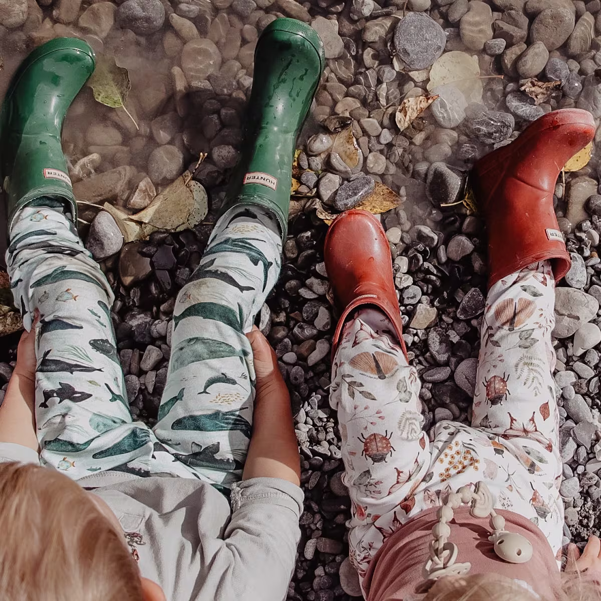 Two kids wearing cotton pants and rain boots