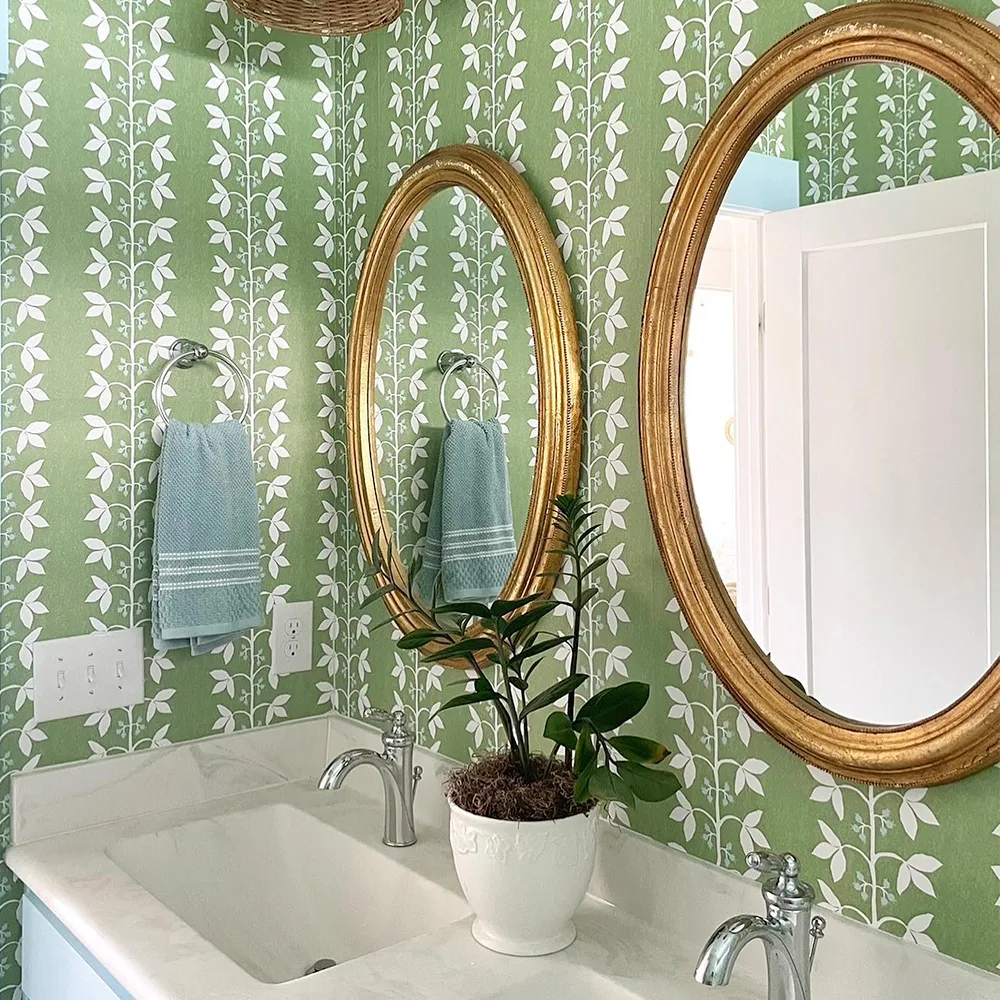 Green vine stripe wallpaper in a bathroom.