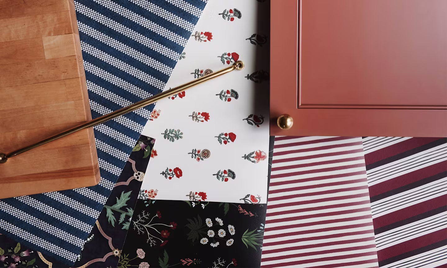 Wallpaper samples along slide cabinet and countertops
