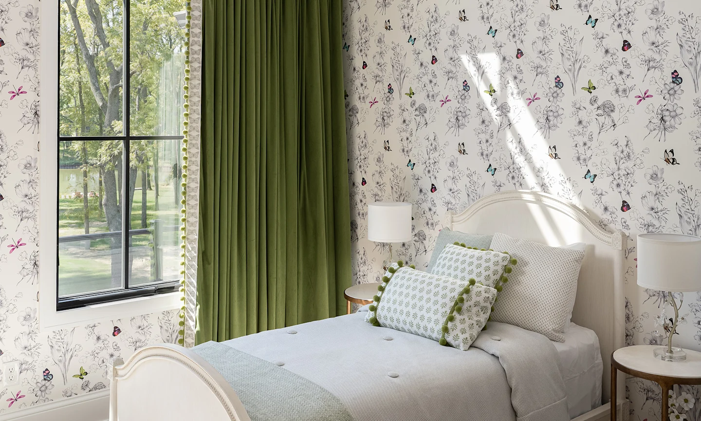 Girls bedroom with white butterfly floral wallpaper.
