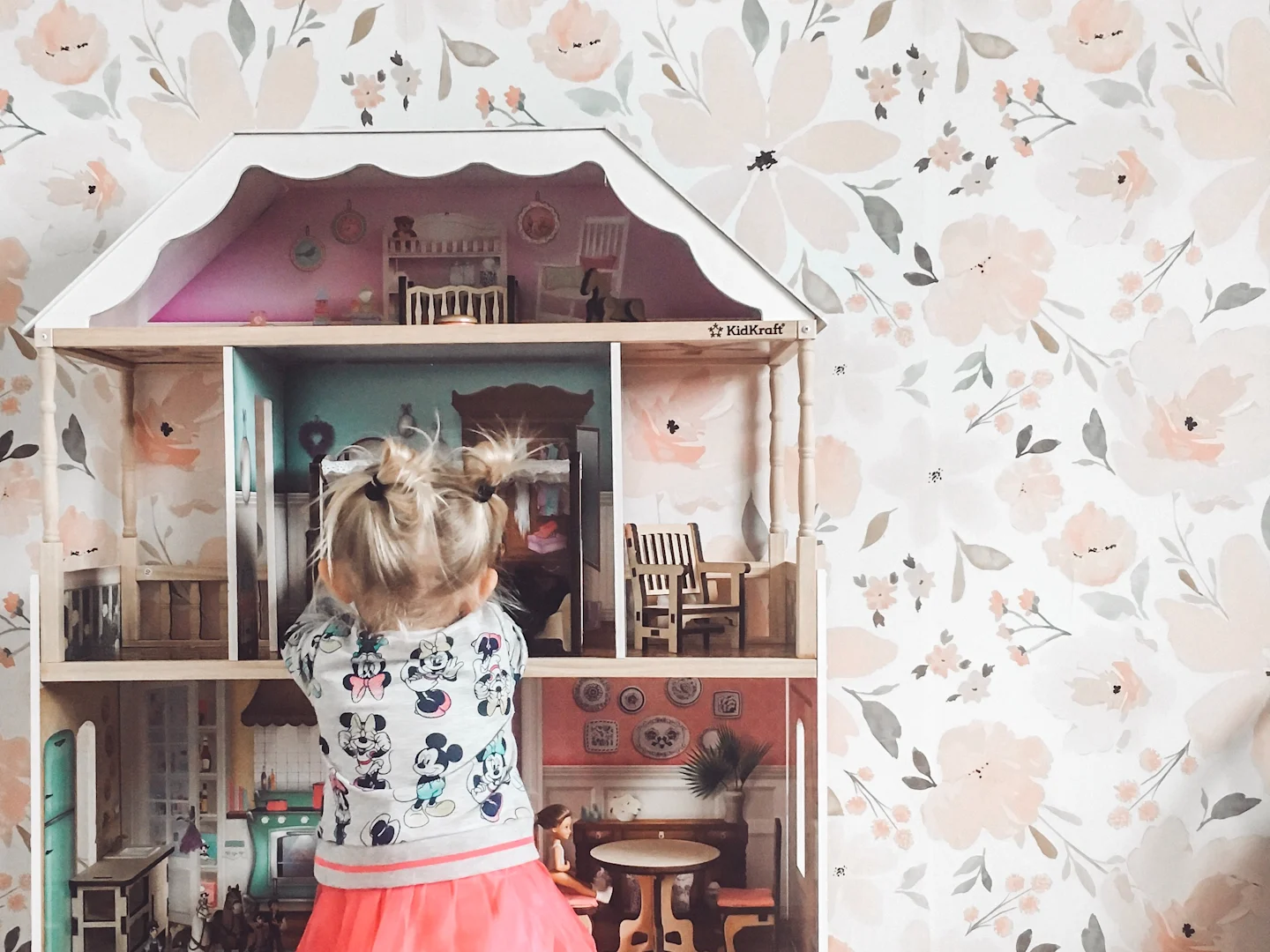 A playroom with blush floral wallpaper with an indybloomdesign print