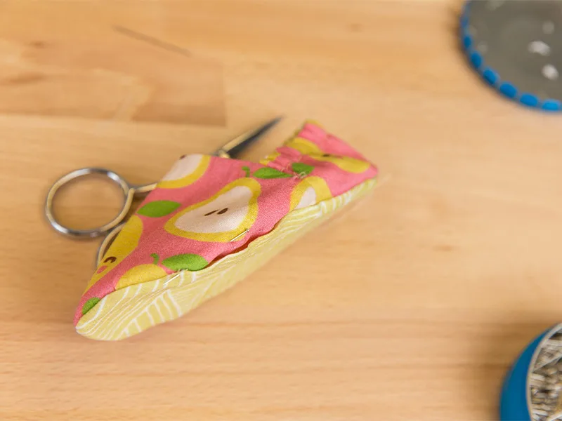 A sewing pin sewing the baby shoe bottom and top.