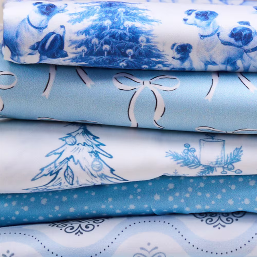 Stack of preppy blue and white christmas fabrics