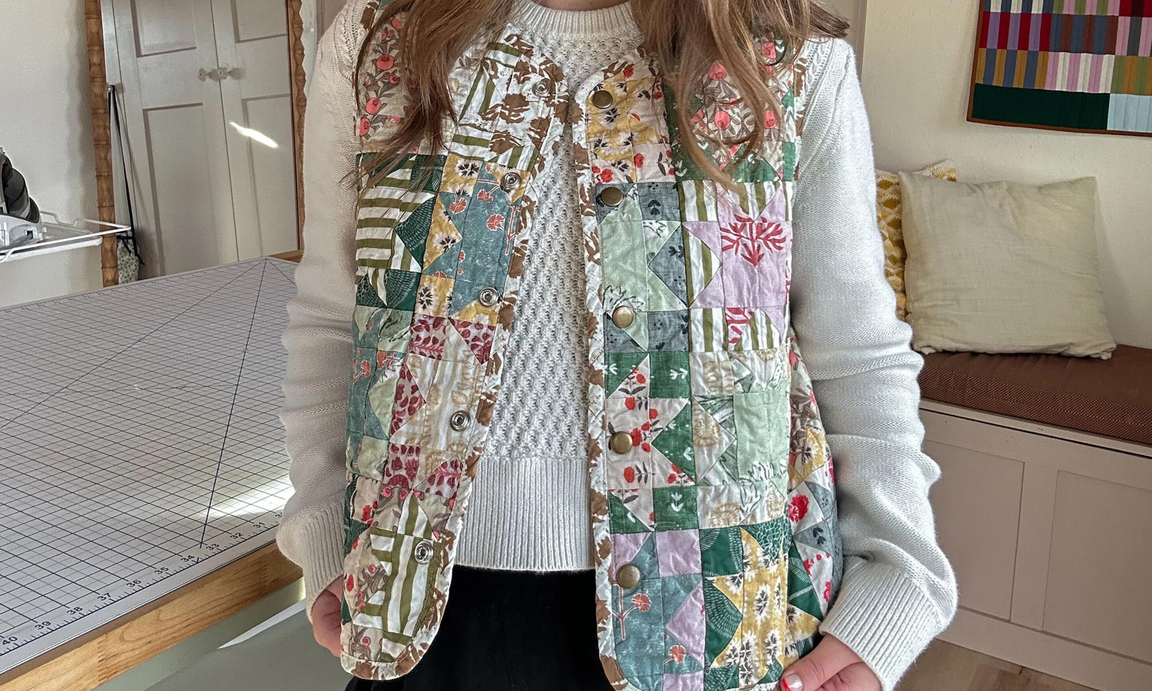 Sydney Graham wearing a quilted vest she made of Spoonflower fabrics.