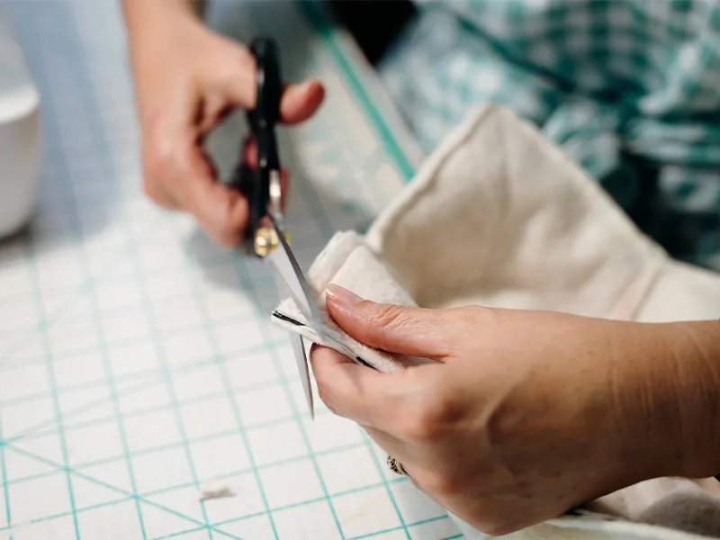 Clipping one corner of the batting with scissors.