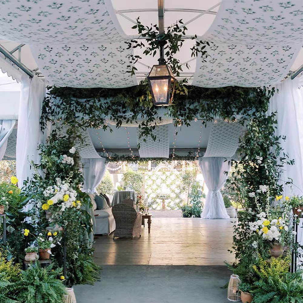 Wedding reception tent with printed fabric draped across the ceiling.