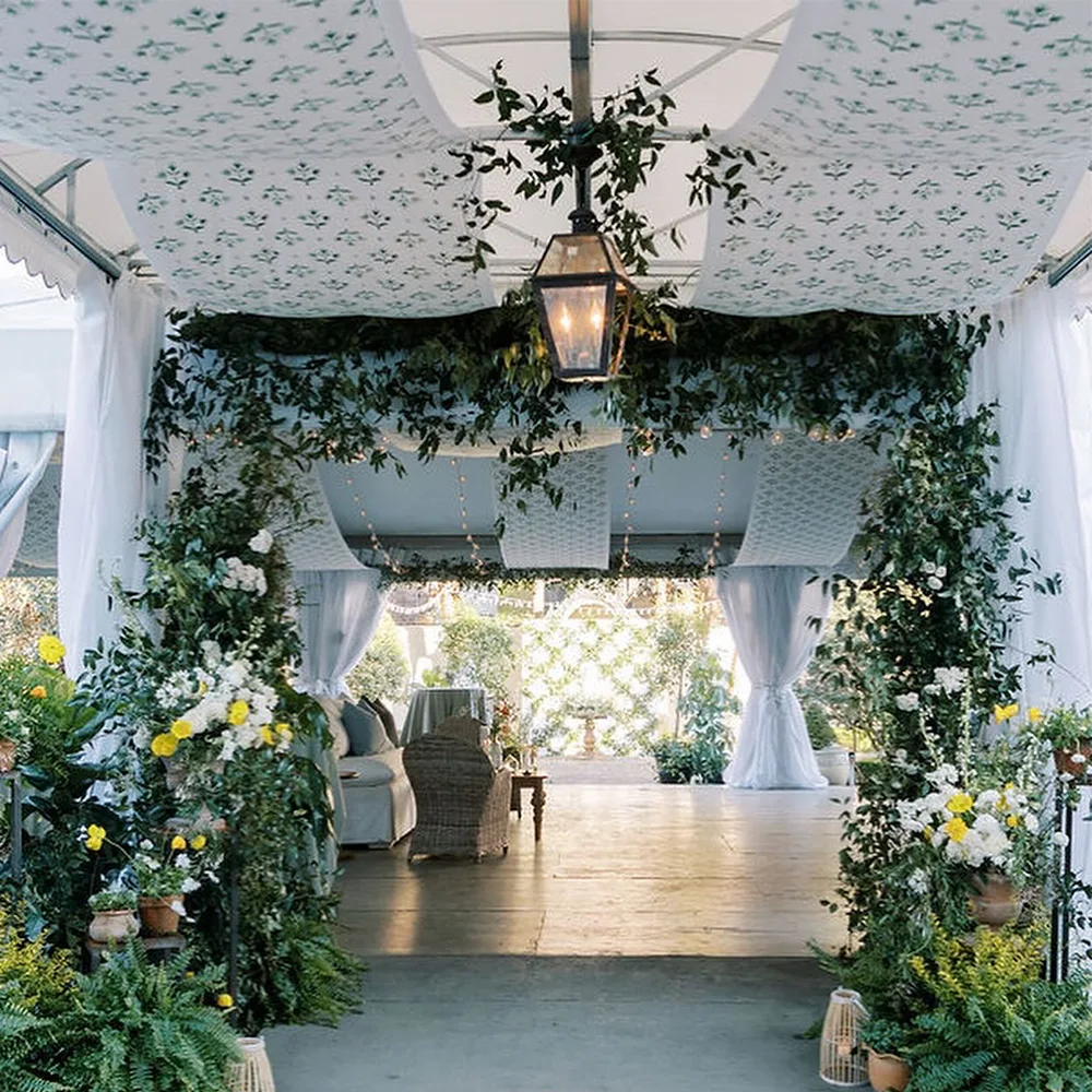 Wedding reception tent with printed fabric draped across the ceiling.