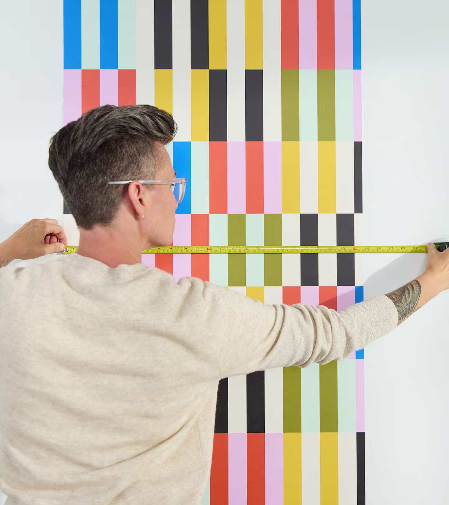 Person measuring the repeat on a roll of wallpaper.