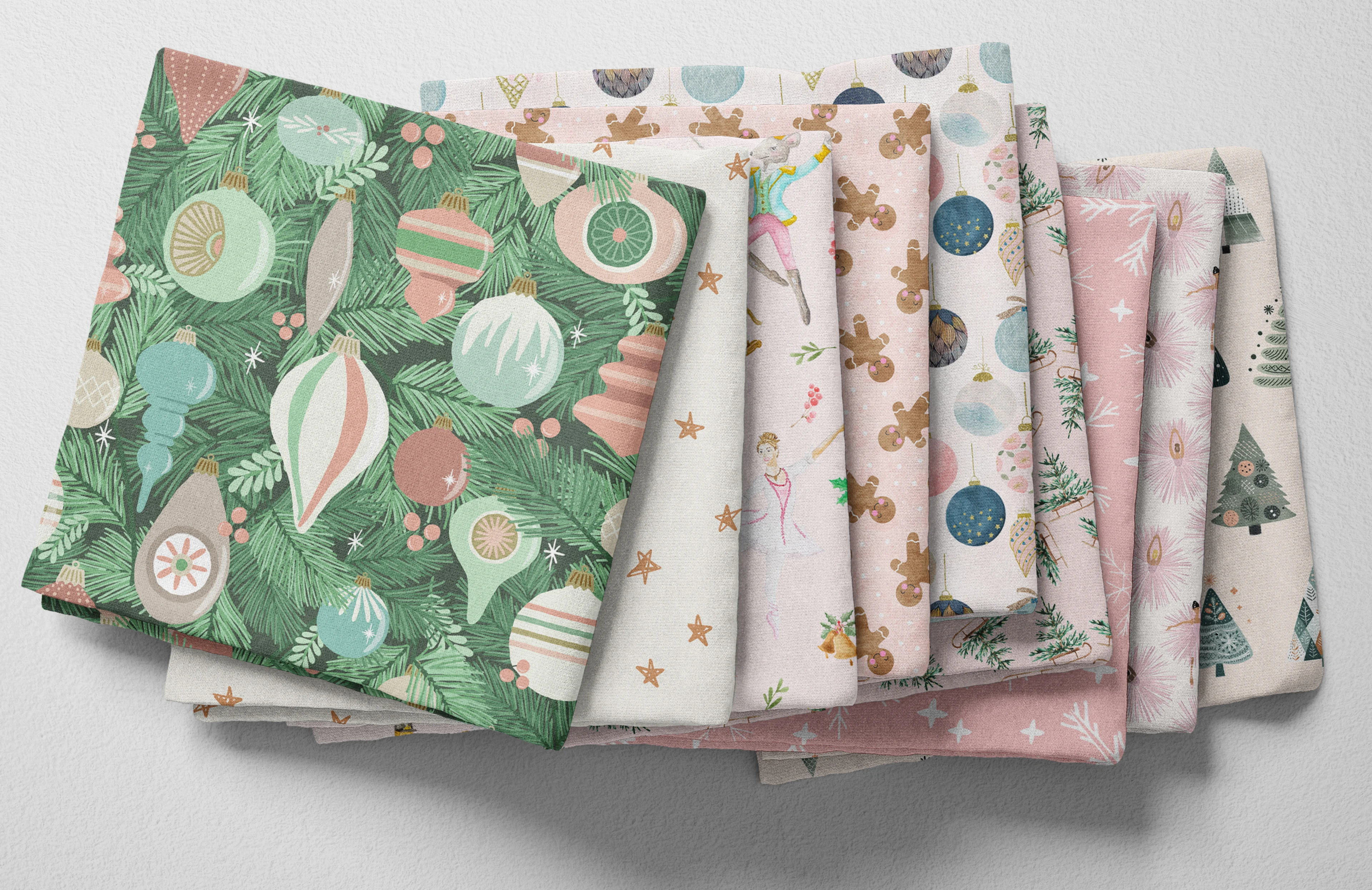 Colorful folded Spoonflower fabric featuring pink and green Christmas ballet designs.