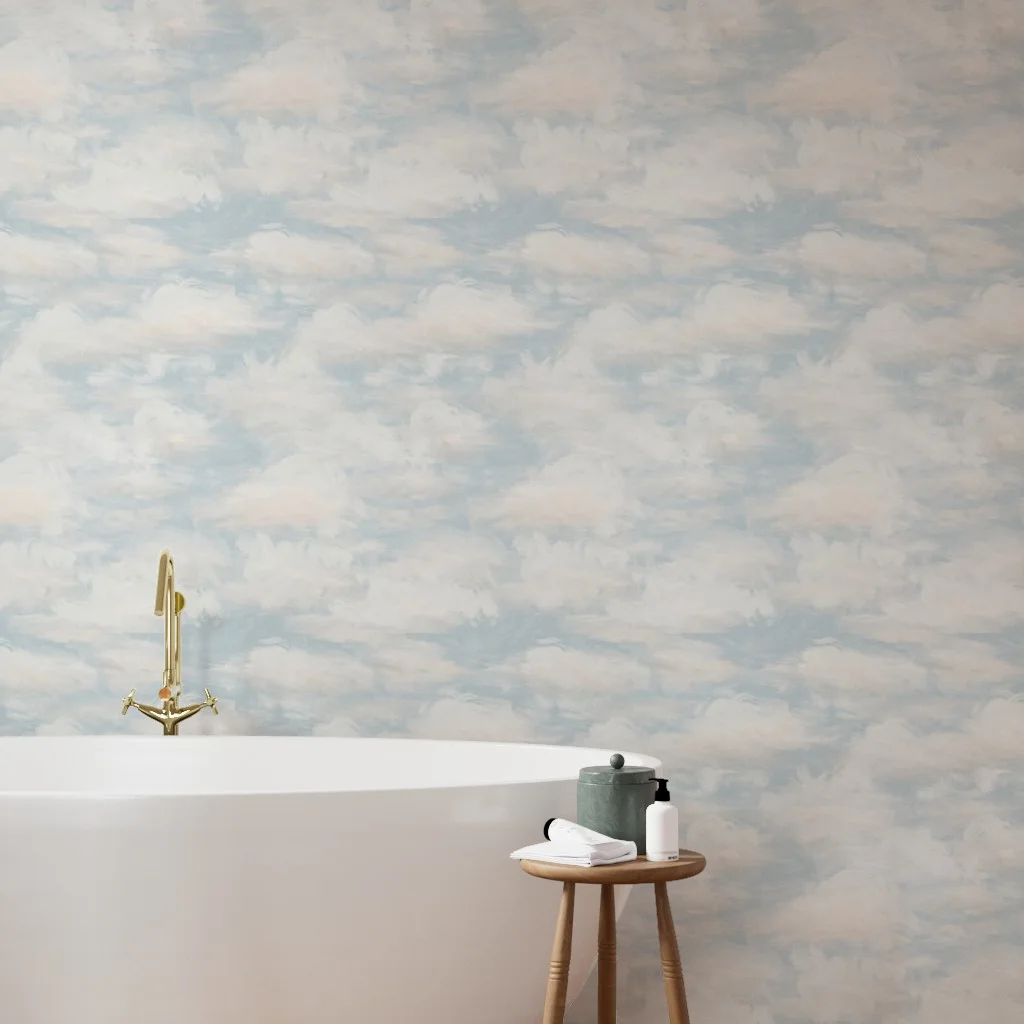 Bathroom with a bathtub in front of a wall with wallpaper with a blue sky and clouds design.
