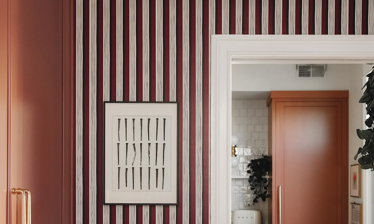 kitchen pantry with red striped wallpaper.
