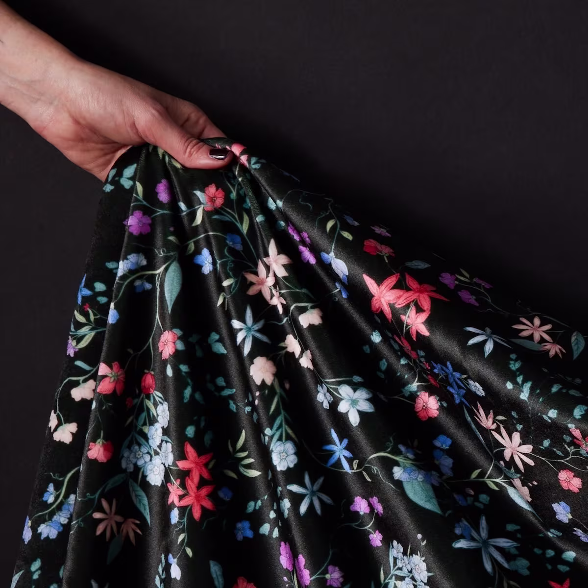 An image of a dark floral on a black background printed on satin