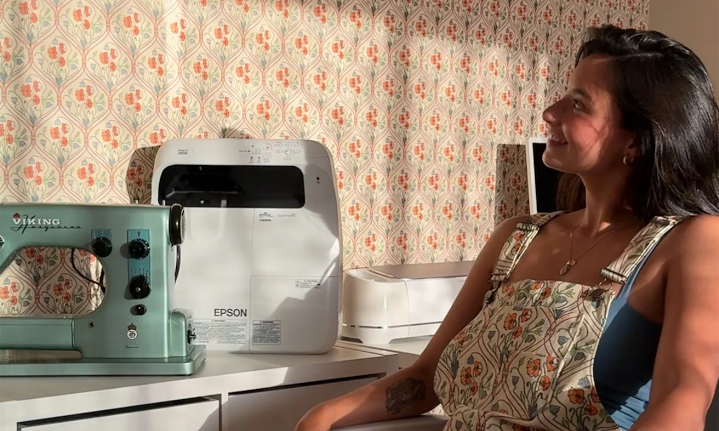 A photo of Mya Rivera at her sewing desk